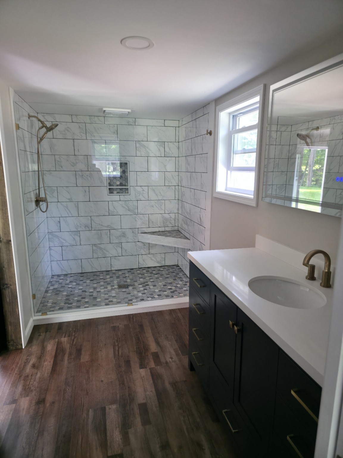 Finished bathroom remodel with walk-in tiled shower